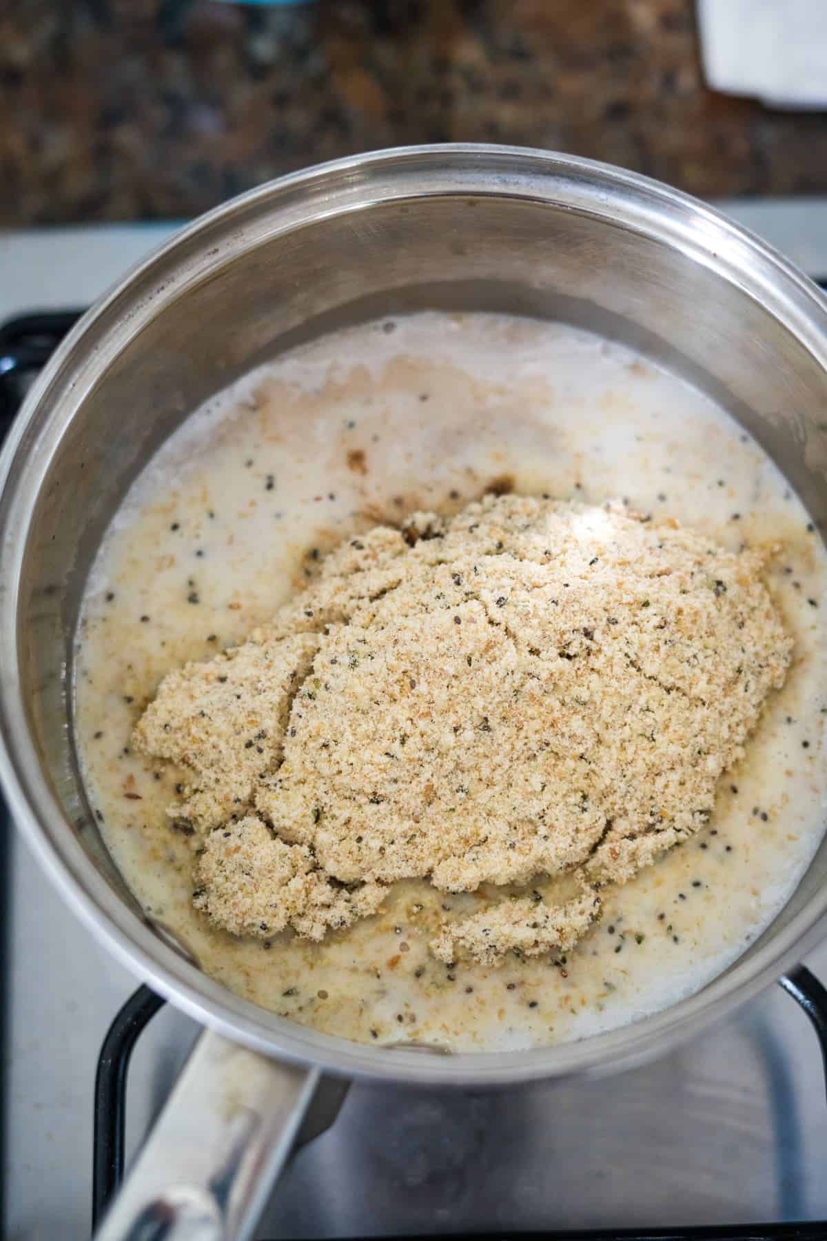 A pan with a protein porridge mixture in it on top of a stove.