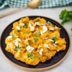 Chicken tikka masala on a plate with almonds.