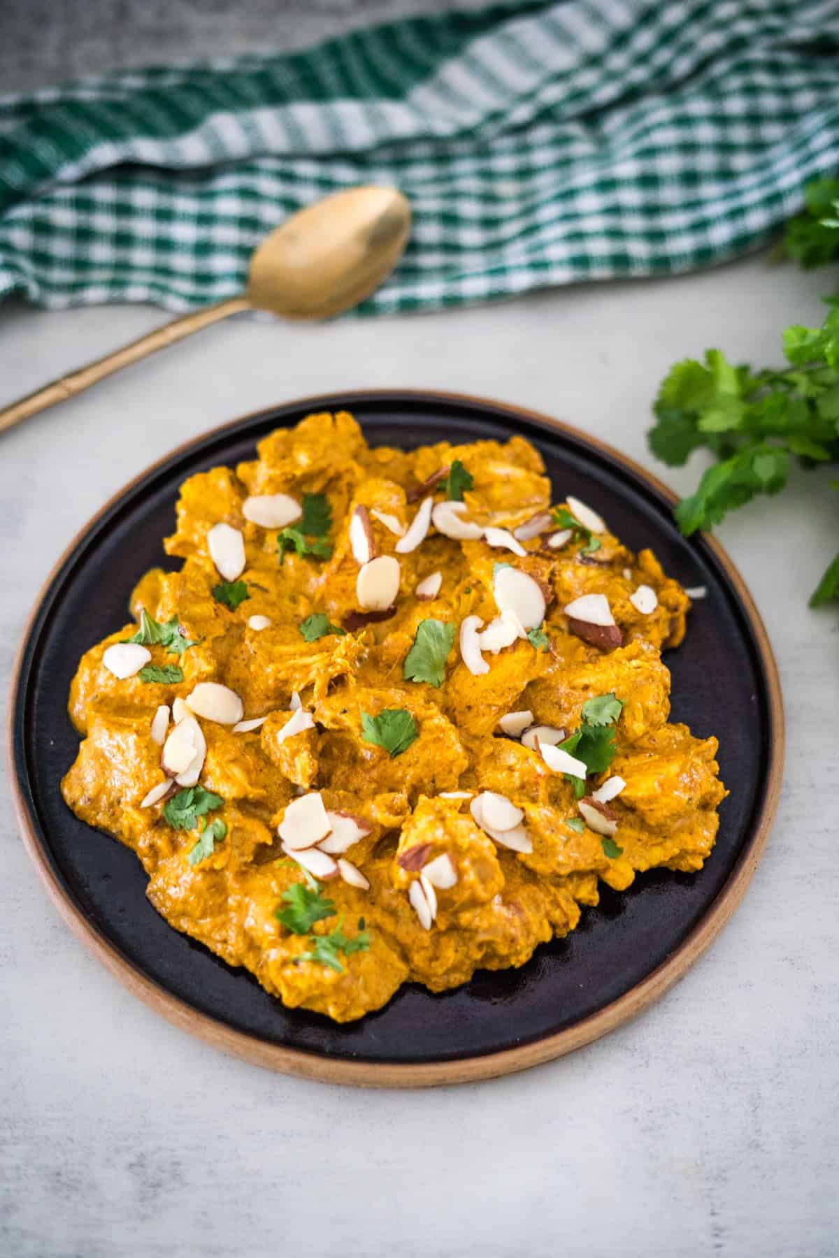 Chicken tikka masala on a plate with almonds.