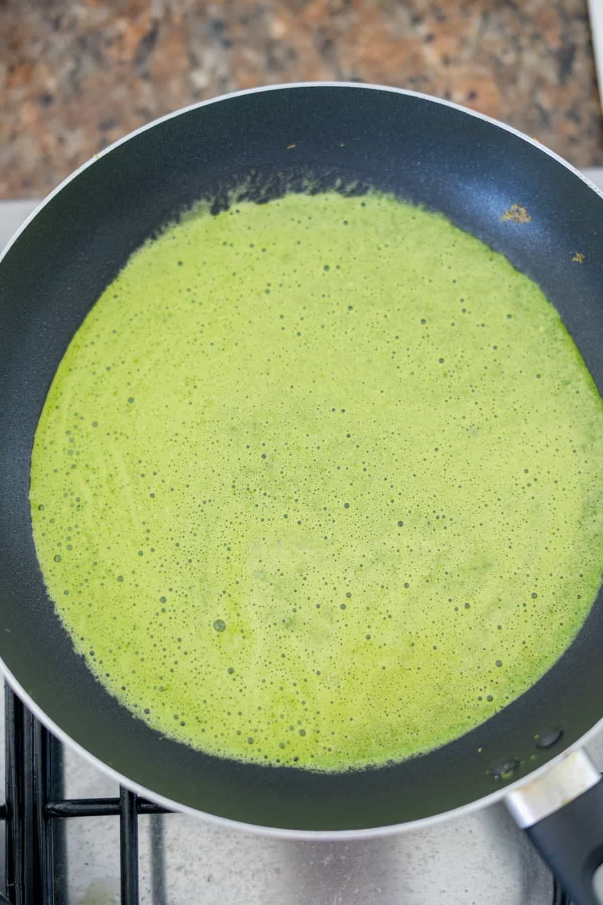 Spinach green curry in a frying pan.