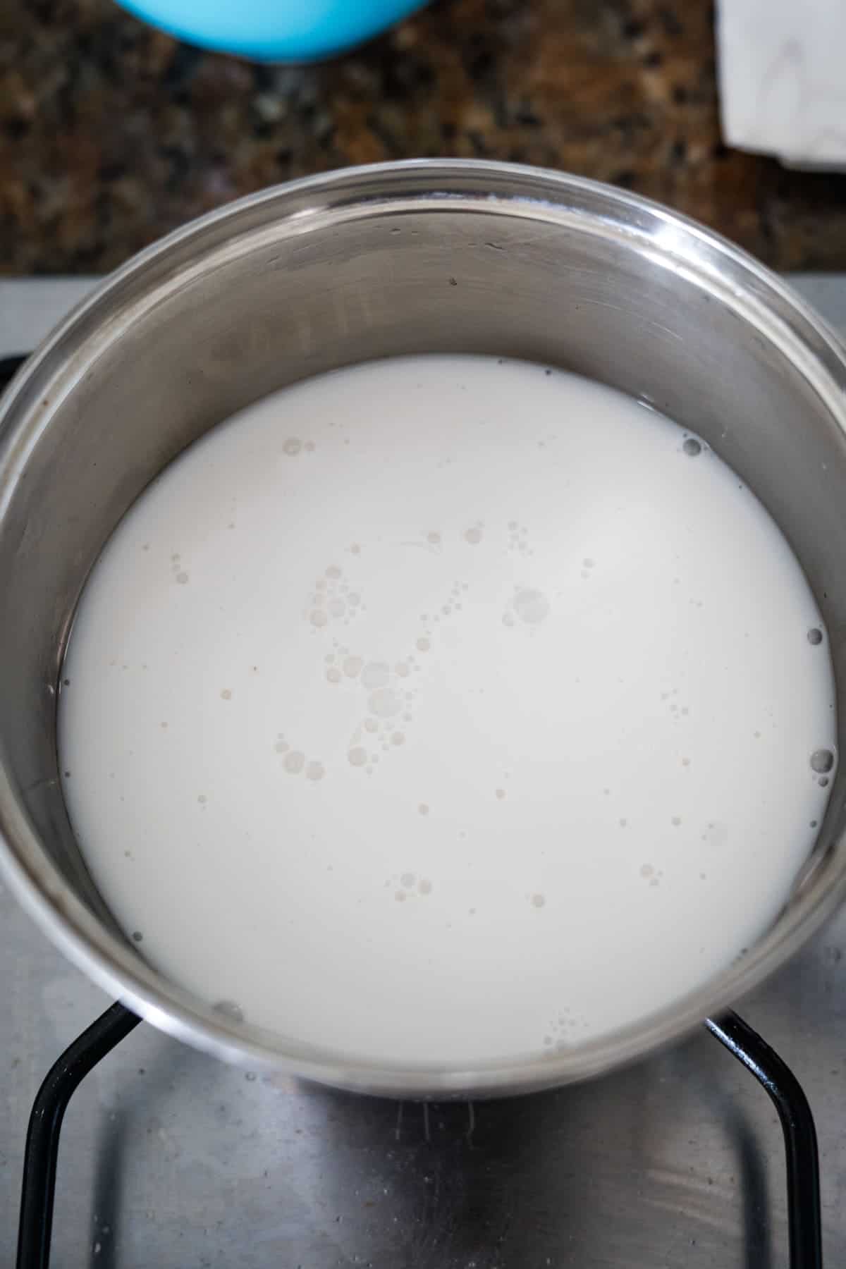 A pot of milk simmering on a stove, transforming into protein-rich porridge.