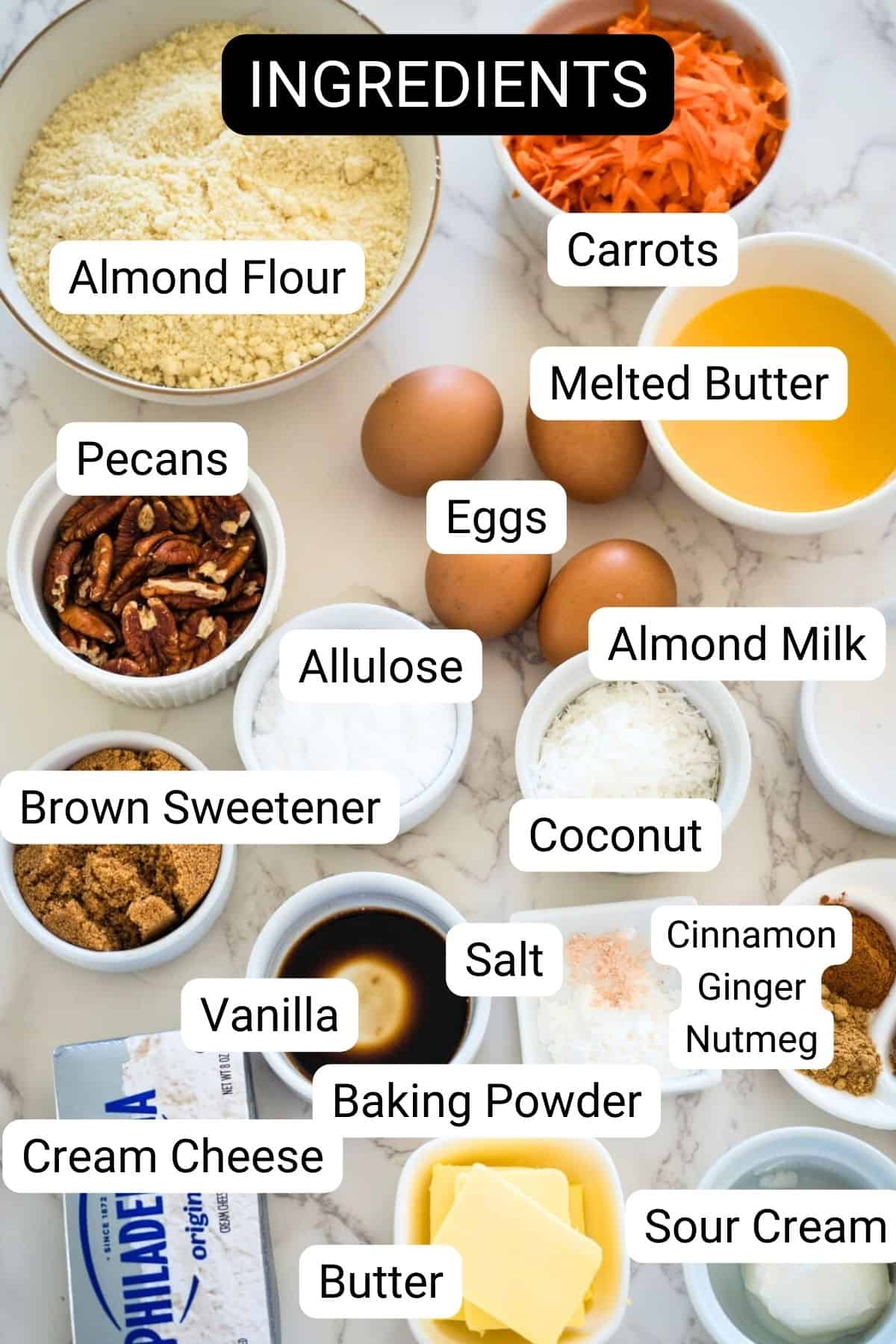 Various baking ingredients labeled and neatly arranged on a marble surface.