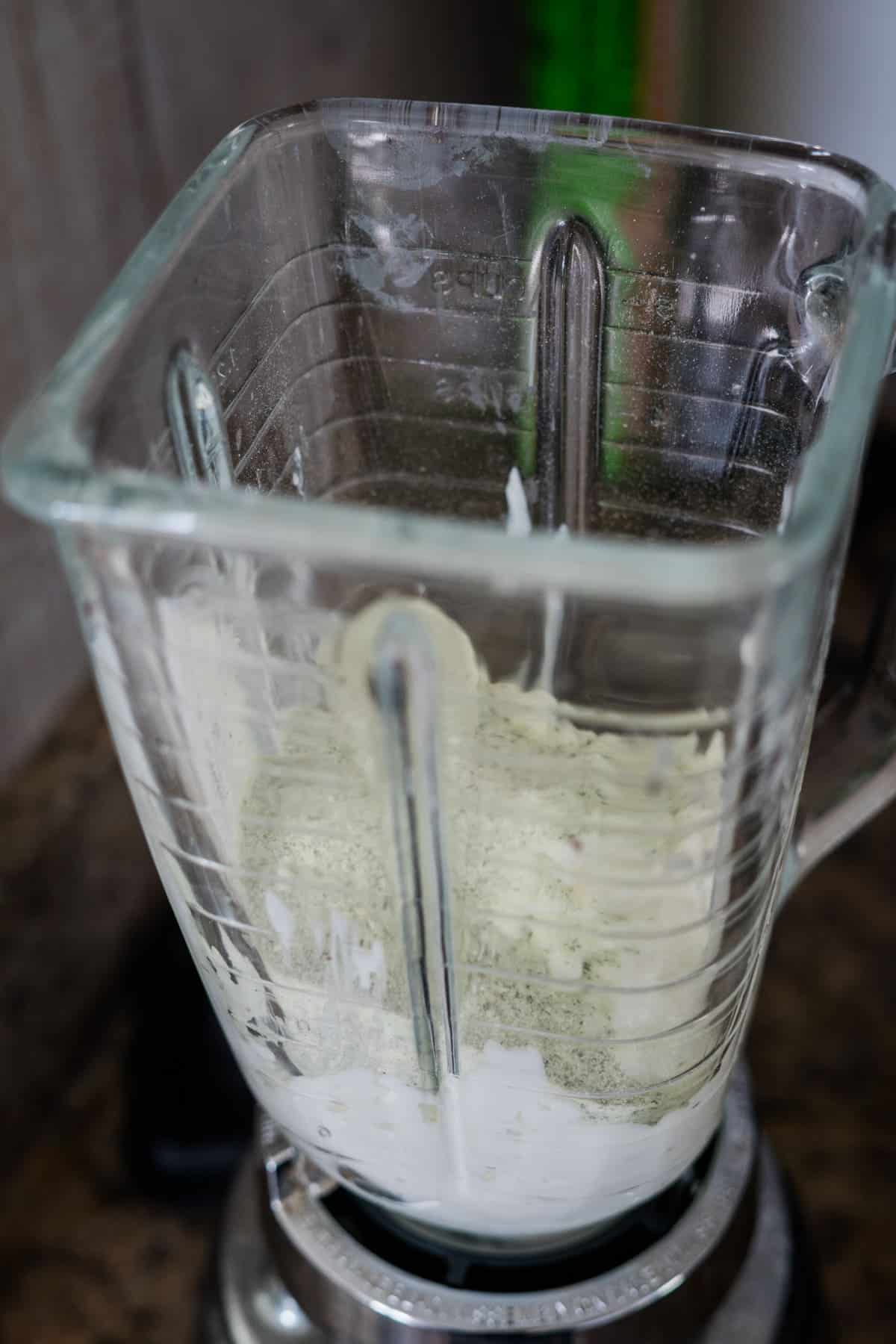 An empty blender with remnants of a blended mixture on the sides.