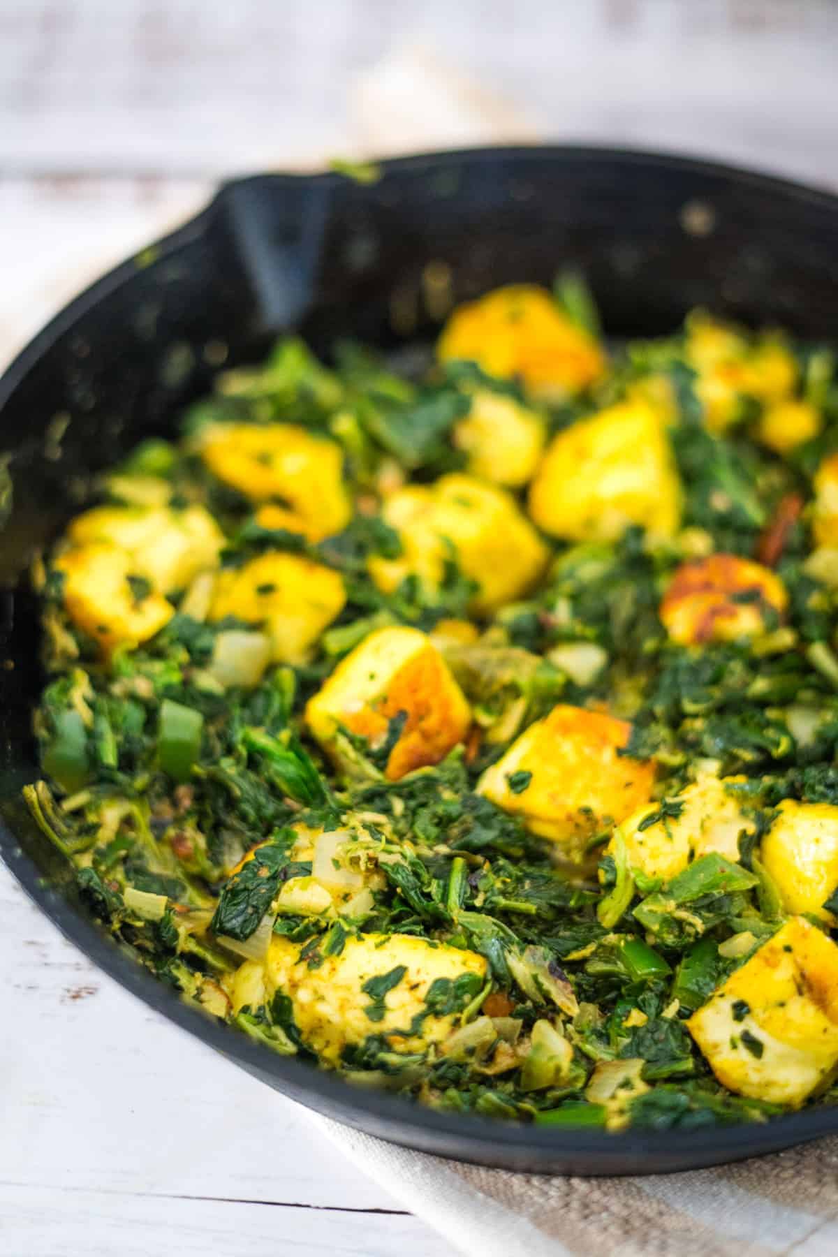 halloumi cheese cubes in a spicy spinach mixture.