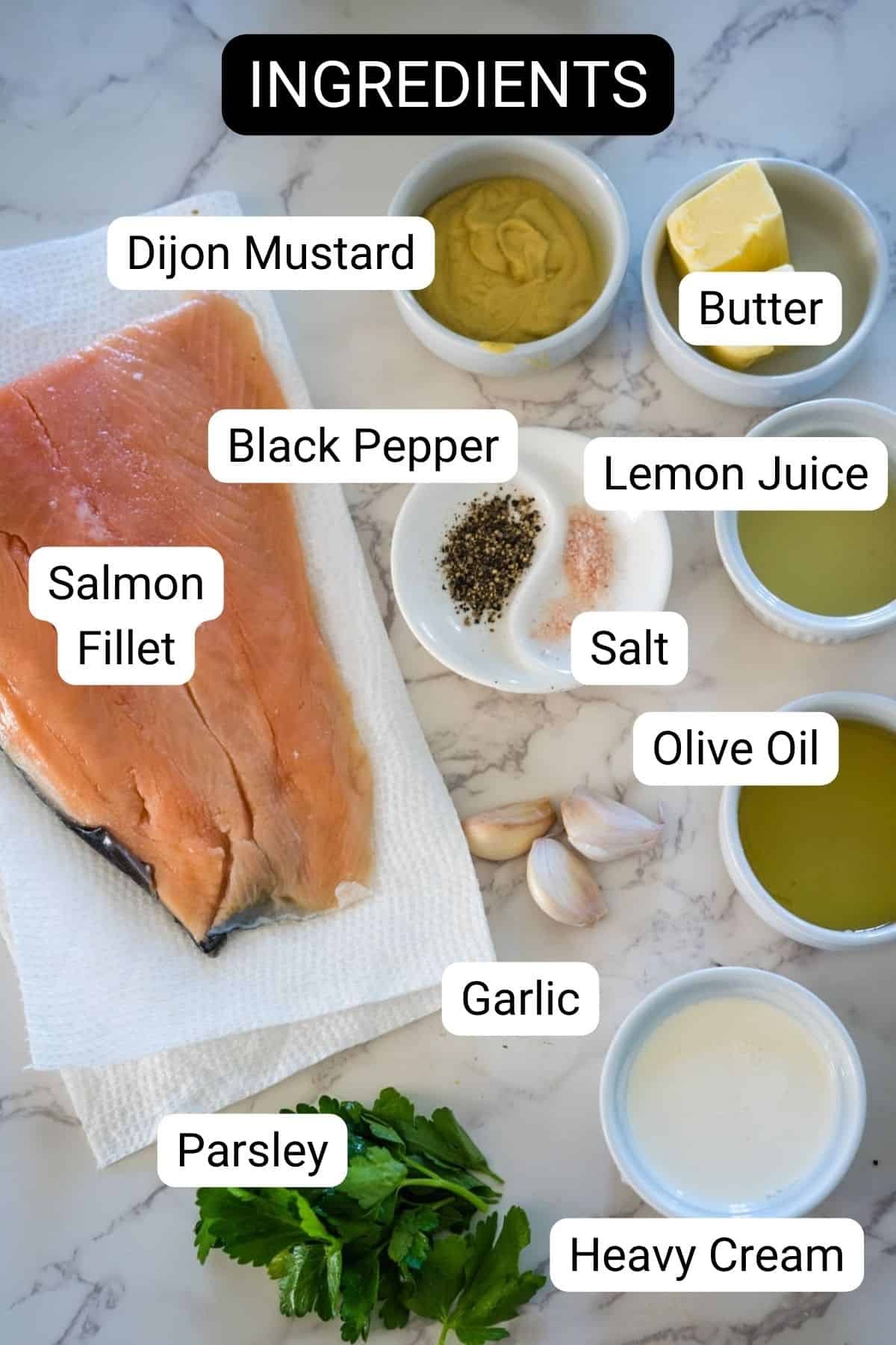 Salmon in lemon creamy sauce recipe ingredients on a marble countertop.