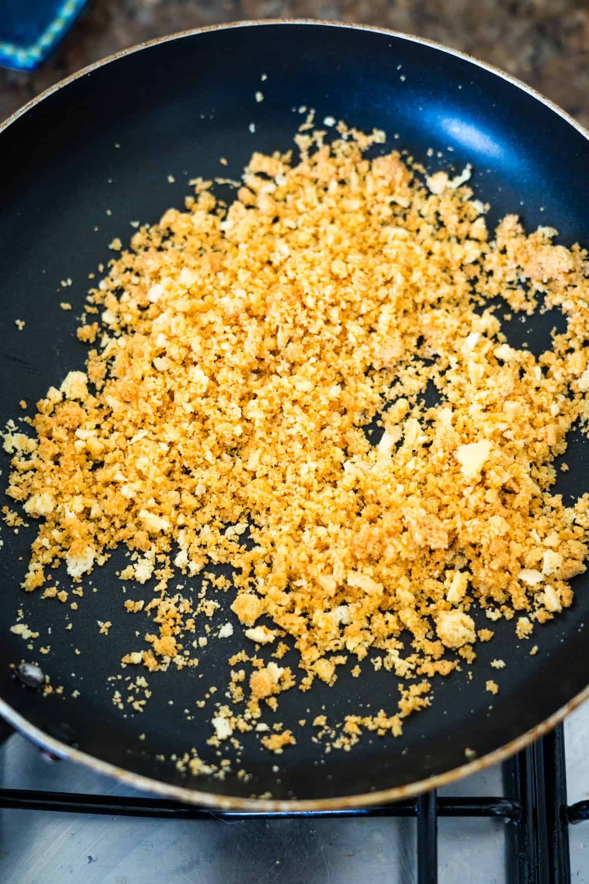 keto bread crumbs and spices in a black frying pan.