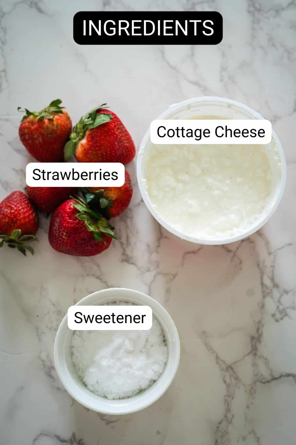 Image of three ingredients for a recipe: four strawberries, a container of cottage cheese, and a small bowl of sweetener.