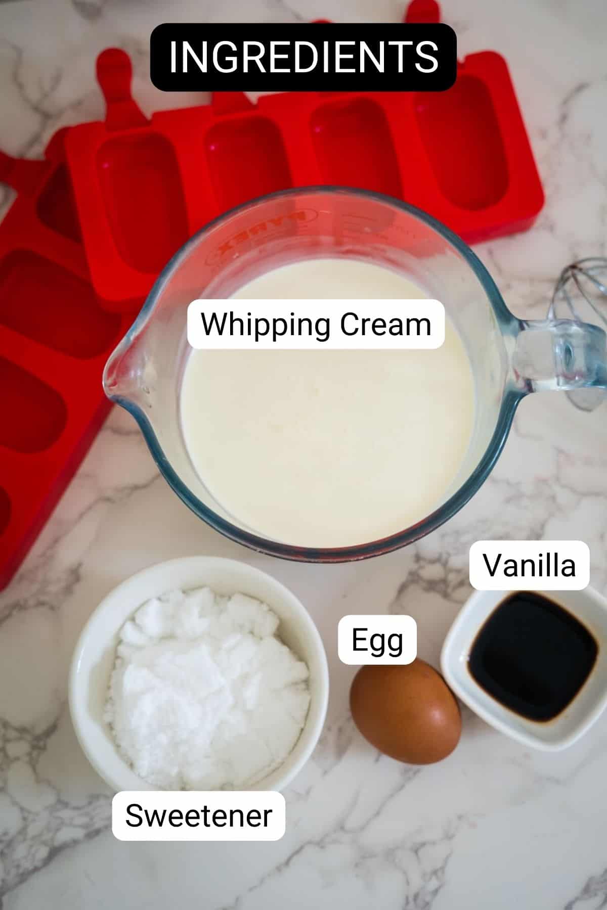 A measuring cup of whipping cream, a small bowl of sweetener, an egg, a small bowl of vanilla, and red silicone molds. Text labels read "Whipping Cream," "Sweetener," "Egg," and "Vanilla. Perfect for making keto ice cream bars.