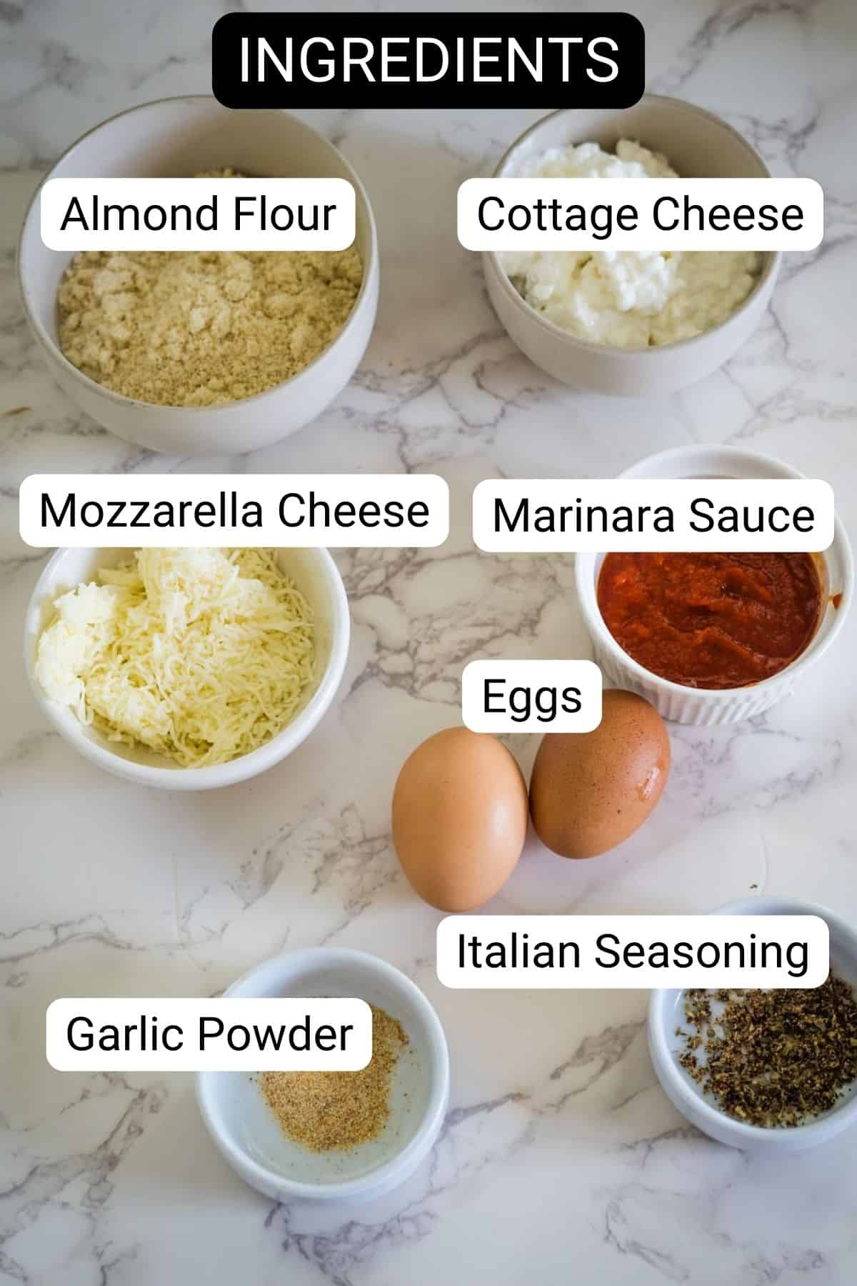 Ingredients displayed: almond flour, cottage cheese, mozzarella cheese, marinara sauce, eggs, Italian seasoning, and garlic powder.